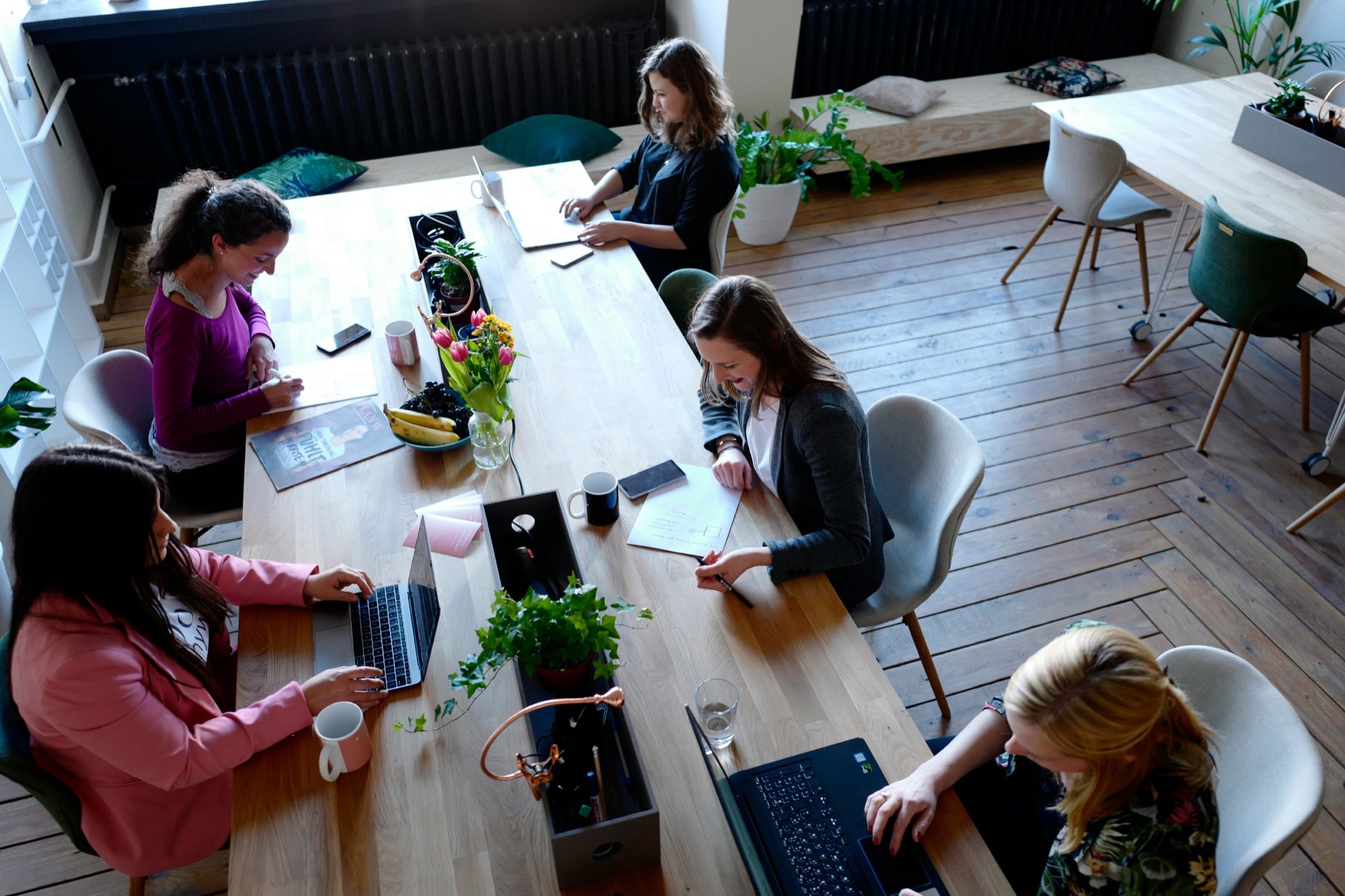 HR professionals at a desk comparing salary benchmarking platforms